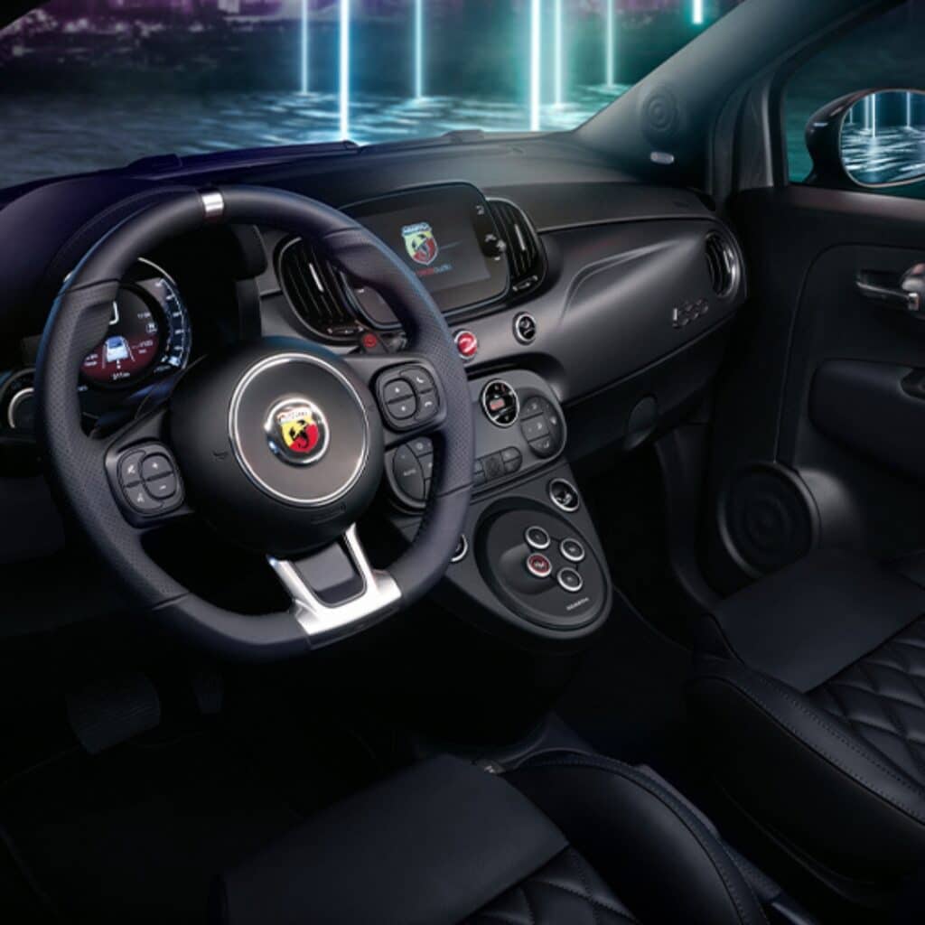 Sports leather steering wheel with controls and satin-chrome detailing in the Abarth 595 Turismo.